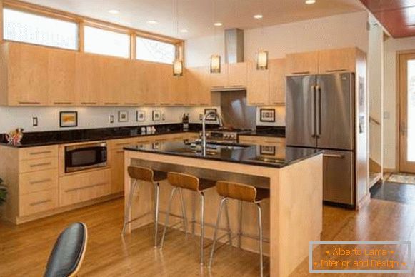Design of a large wooden kitchen with an island in a private house Photo