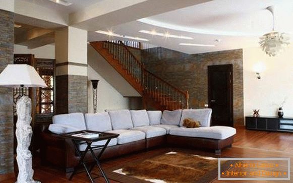 Interior of the living room with a staircase in a private house - photo of a beautiful design