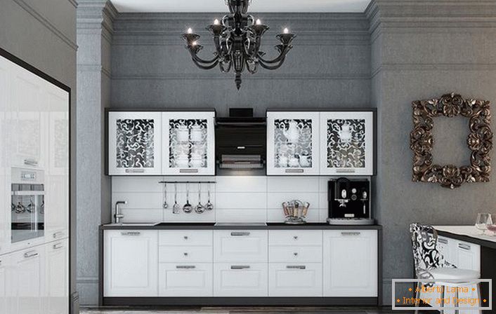 The kitchen is made in an advantageous combination of contrasting white and black colors. Glossy surfaces gracefully fit into the interior in the neoclassic style.