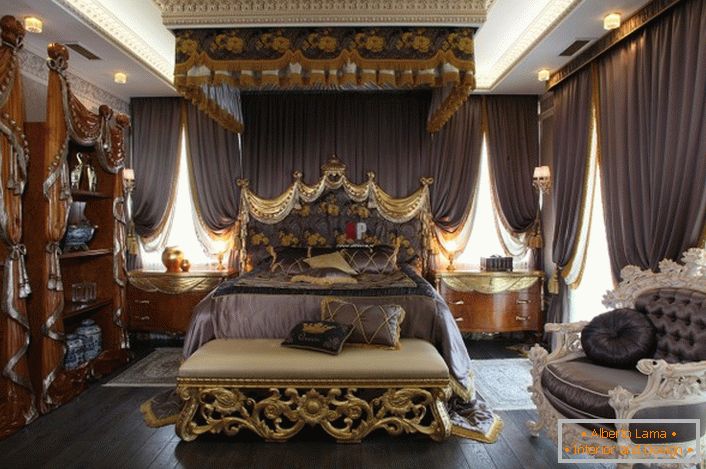 Luxury bedroom in Baroque style. In the center of the composition is a massive bed with a high decorated headboard.