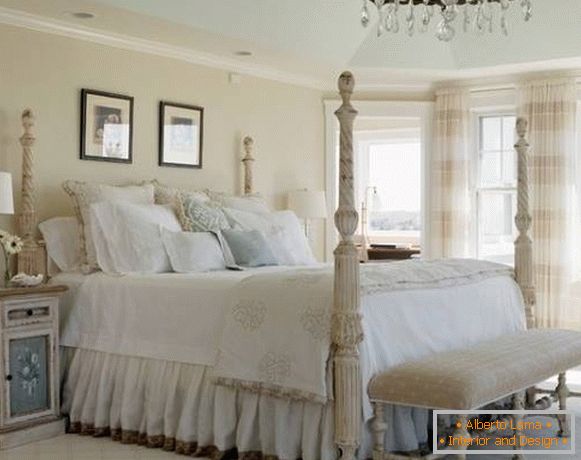 The bedroom in the style of the shebbie chic with a large bed with columns