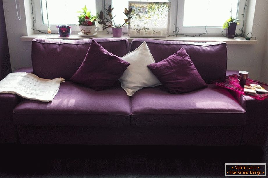 Purple sofa with pillows