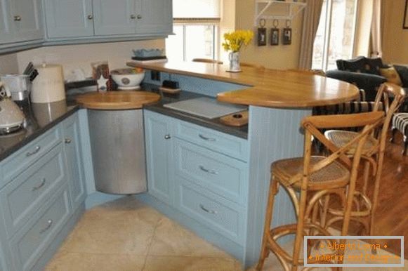 Blue corner kitchen set with a bar counter - photo in the interior
